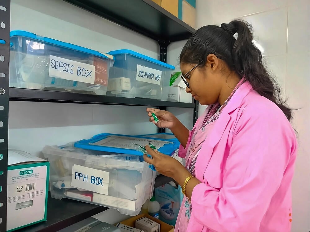 Midwife Supervisor Arafin Mim checks for materials at the facility.