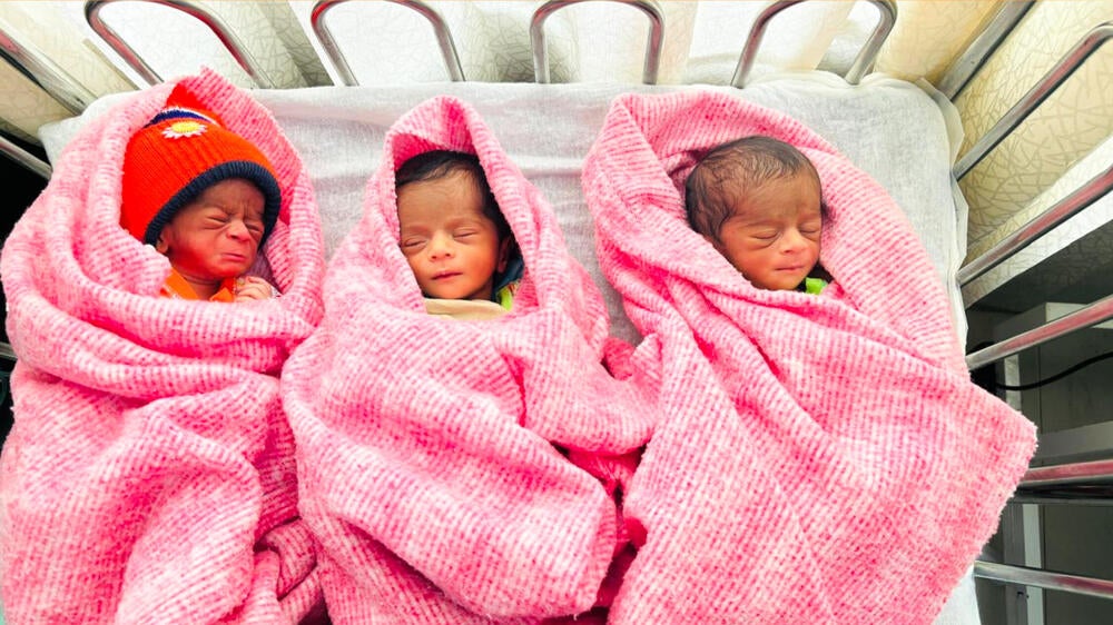 Triplets—two boys and a girl—were born into the world.