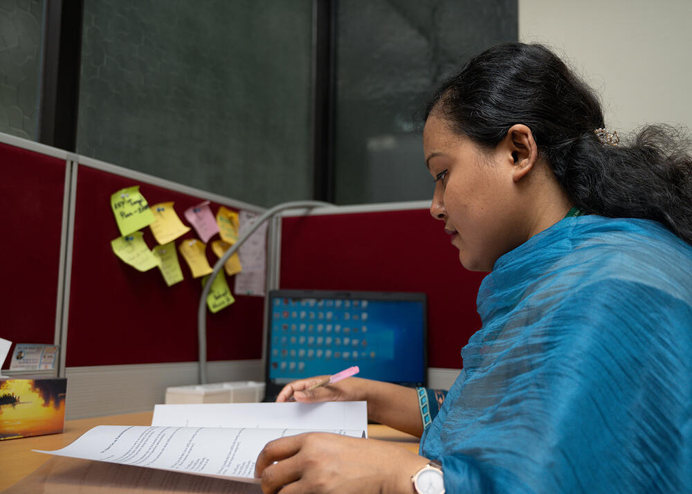 Nazneen at her desk studying cases