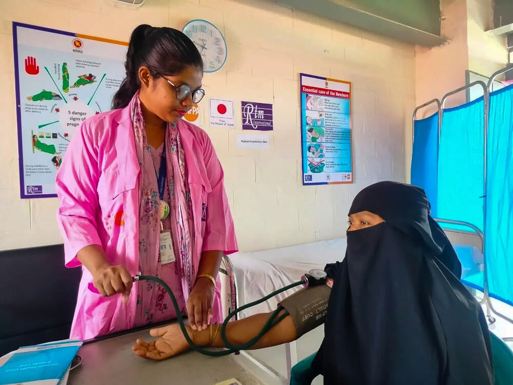 Midwife supervisor Arafin Mim measures a woman’s blood pressure. 