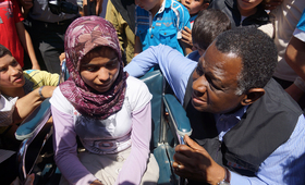 UNFPA Executive Director, Dr. Babatunde Osotimehin, with a Syrian teenage girl with special needs at the Nizip Camp in Turkey. Photo: UNFPA/Nezih Tavlas